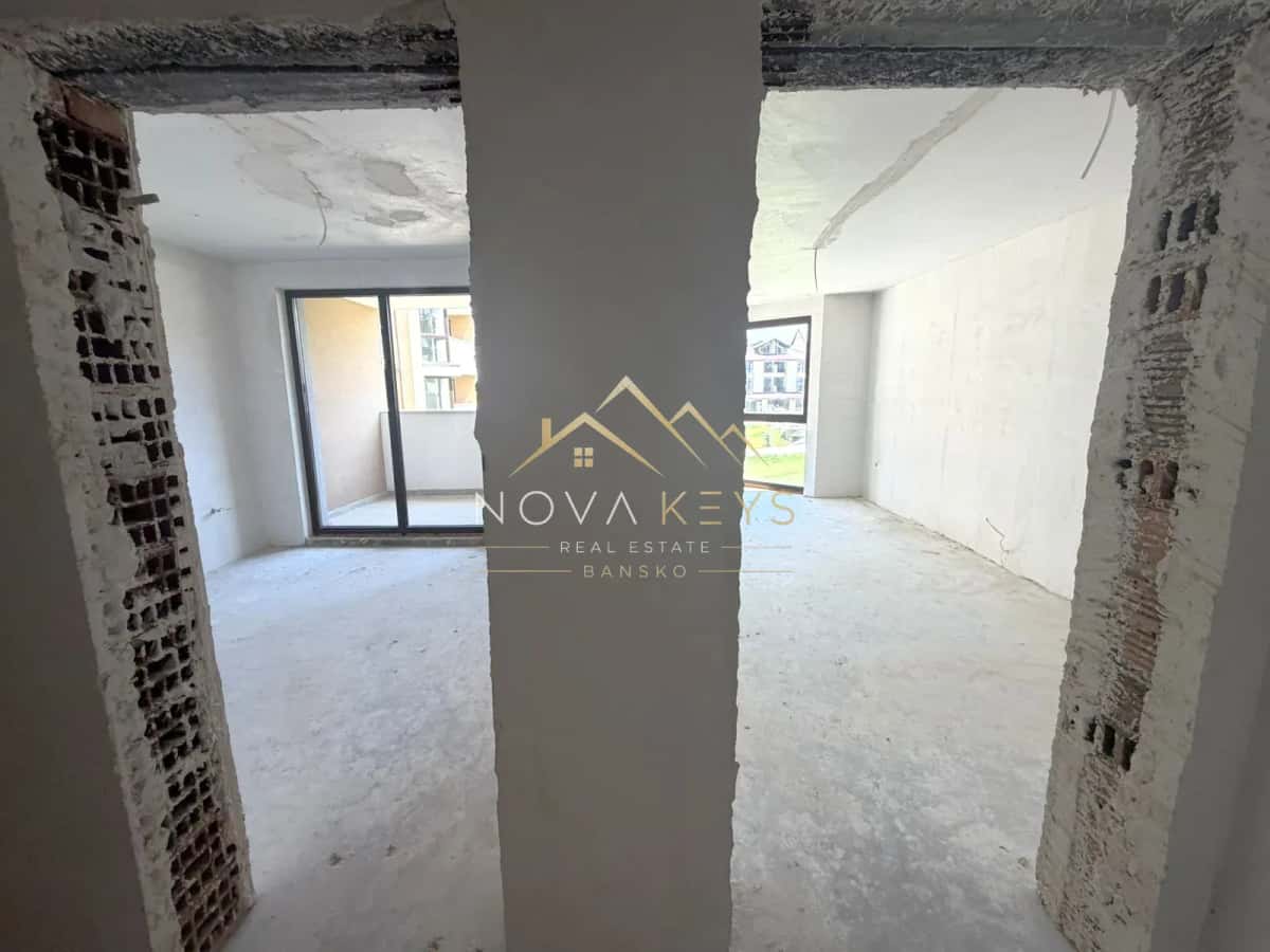 unfinished room with balcony doors and window, two-bedroom apartment for sale in the Bansko ski area.