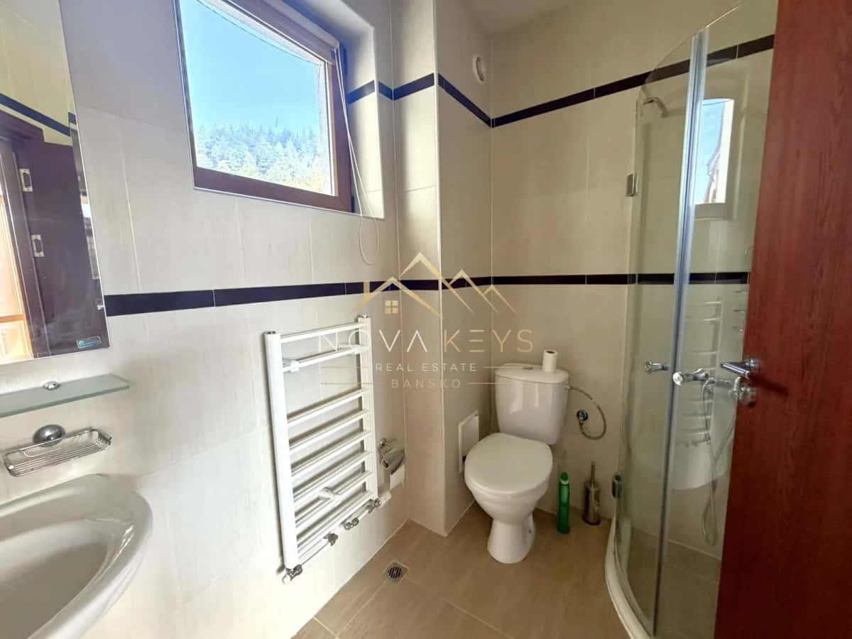 Bathroom with shower enclosure, toilet, and window, two-bedroom apartment for sale in Razlog.