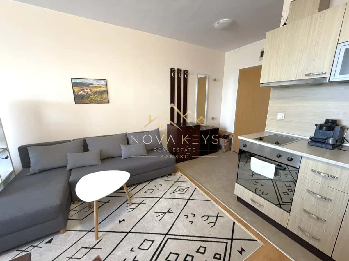Open-plan living room with sectional sofa and kitchen, studio for rent in Razlog.