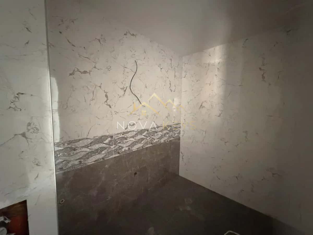 Unfinished tiled bathroom wall, studio for sale in the Bansko ski area.