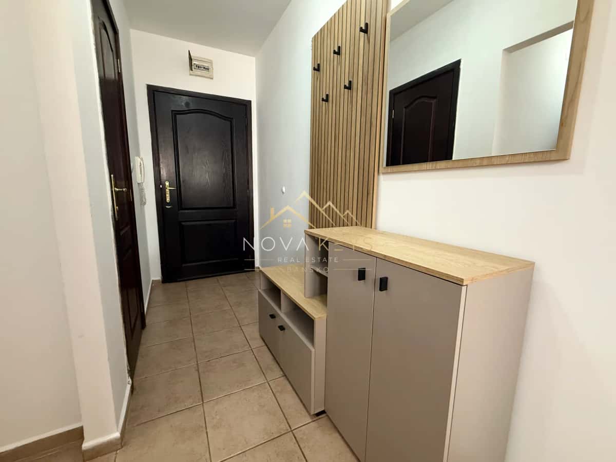 entry hallway with storage cabinet and mirror, three-bedroom apartment for rent in Bansko centre.