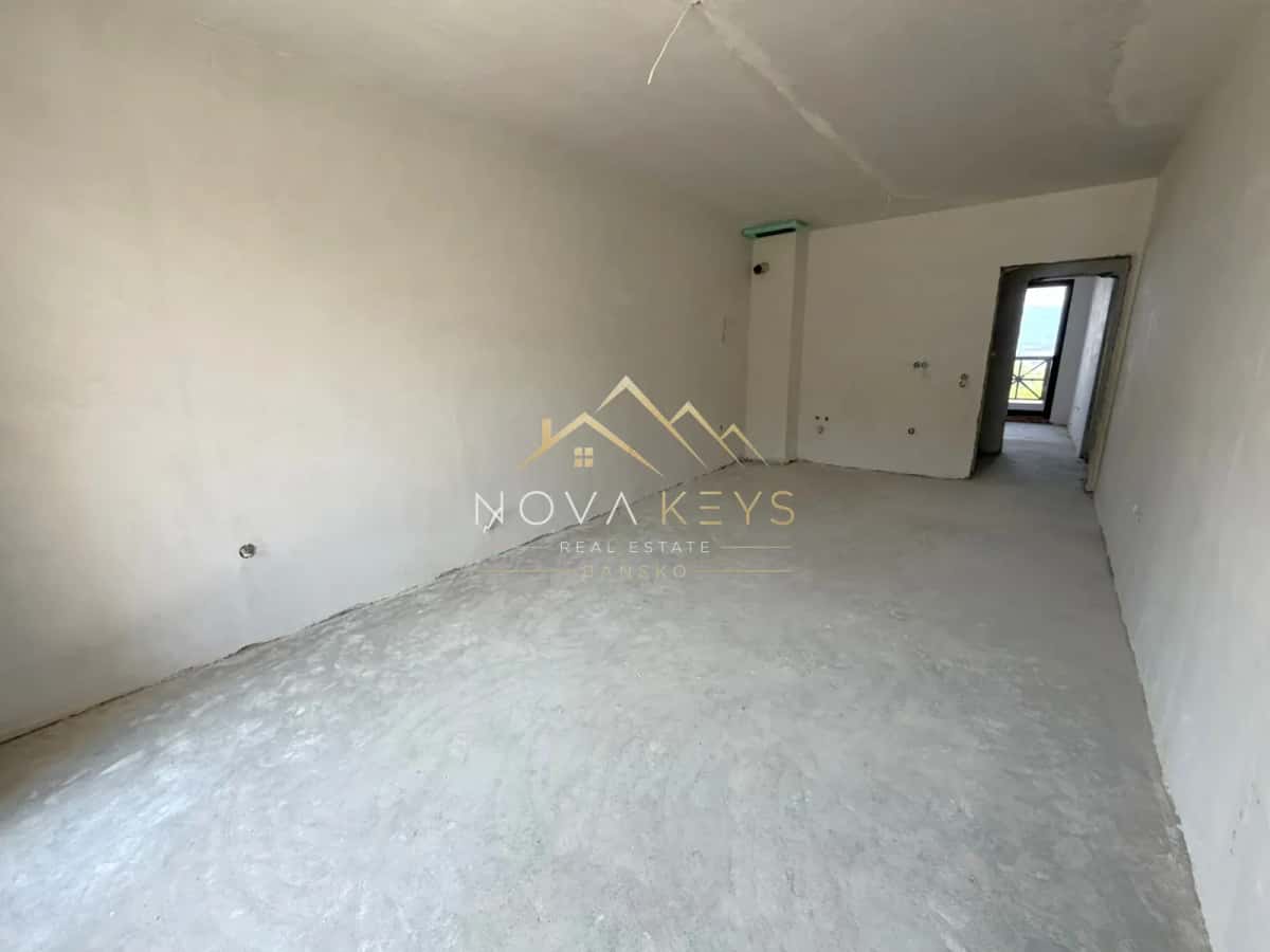 unfinished room with concrete floor and doorway, three-bedroom apartment for sale in the Bansko ski area.
