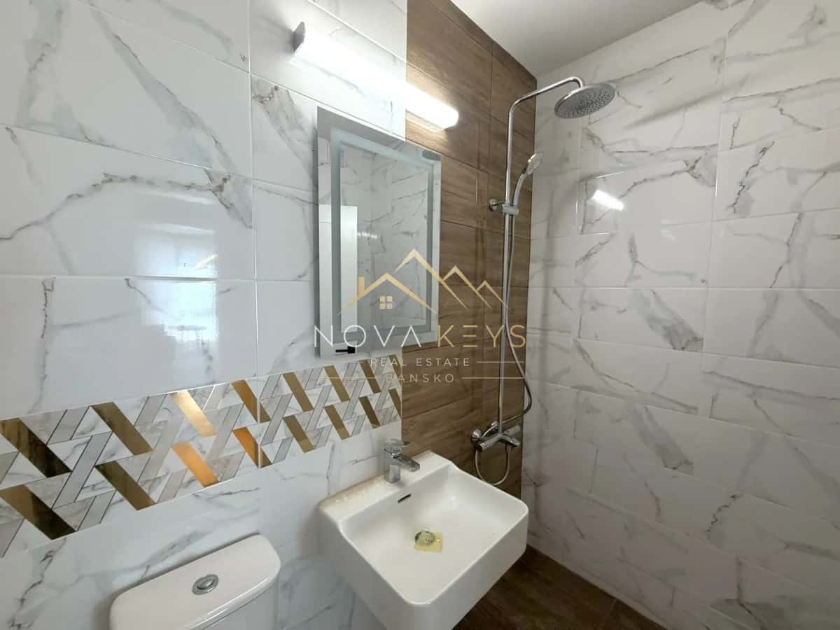 Modern bathroom with shower, sink and toilet, studio for sale in the Bansko ski area.