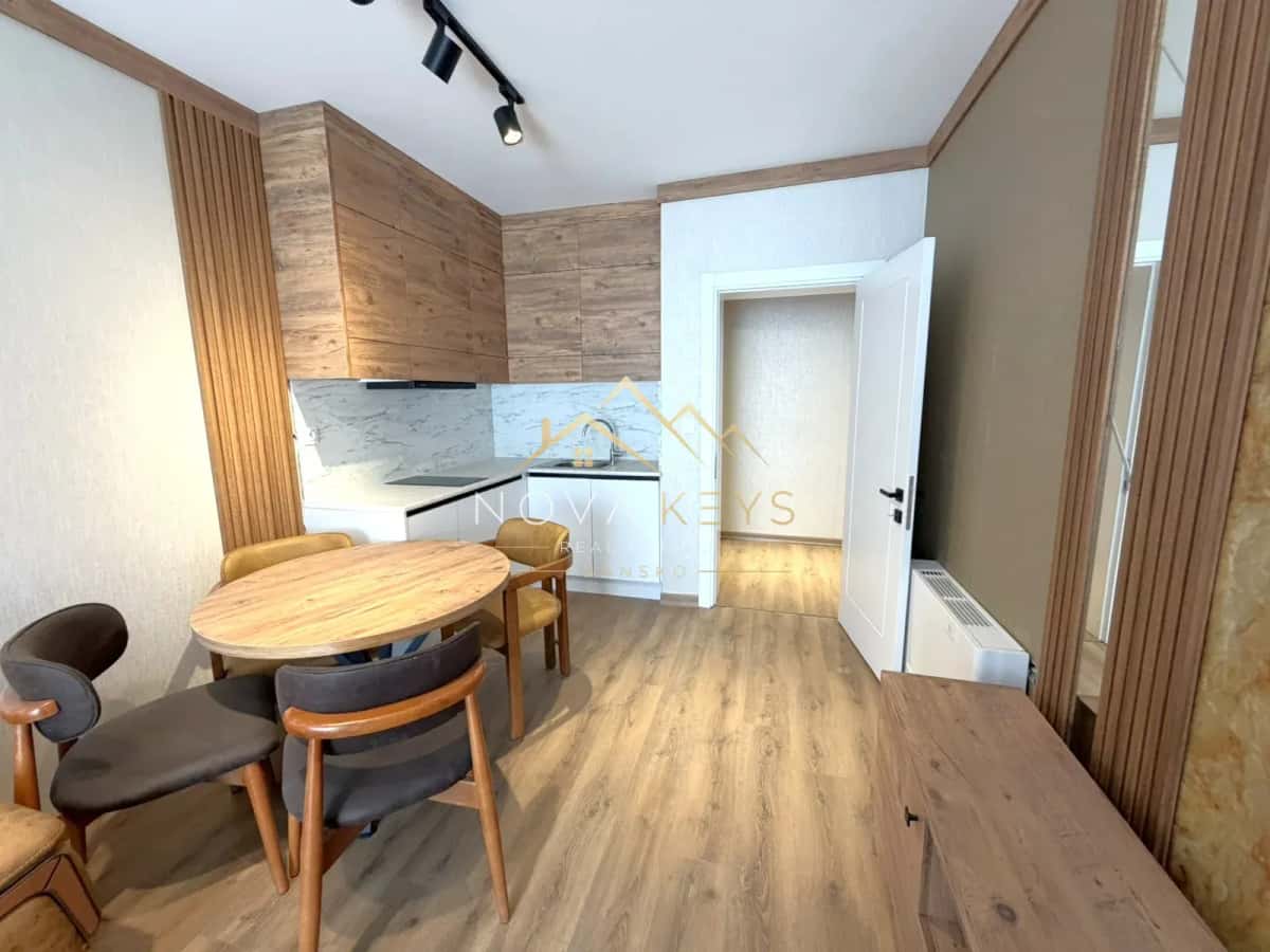 modern kitchen dining area with wooden table and chairs, two-bedroom apartment for sale in the Bansko ski area.