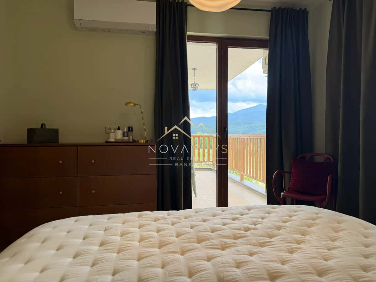 Bedroom with tufted bed and balcony view, two-bedroom apartment for sale in Pirin Golf.