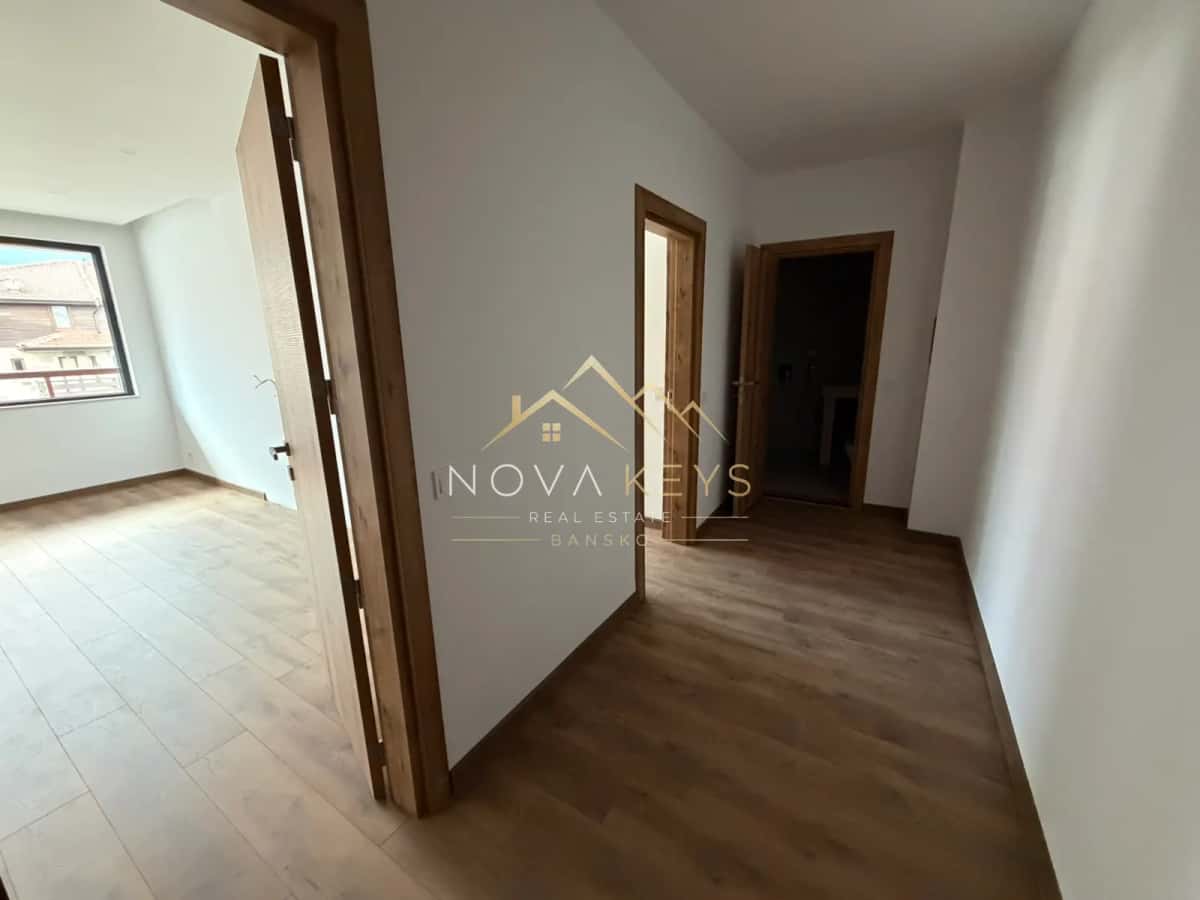 empty hallway with wooden doors, three-bedroom apartment for sale in the Bansko ski area.