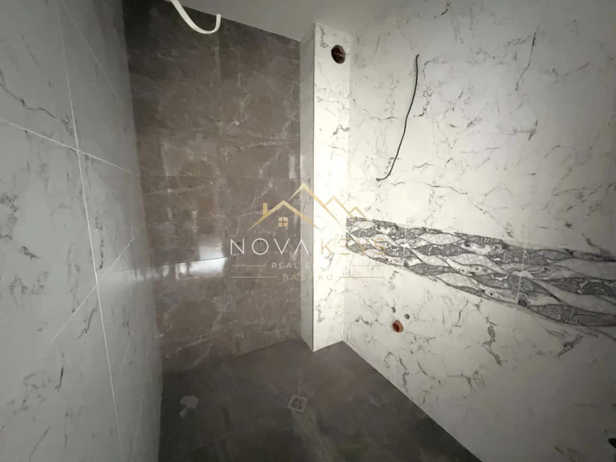 unfinished tiled shower area, two-bedroom apartment for sale in the Bansko ski area.