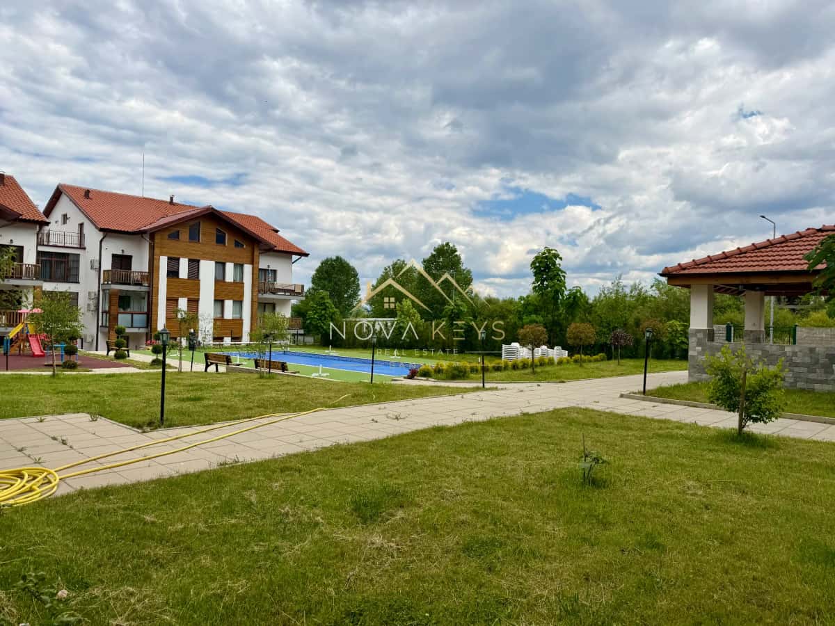 Residential courtyard with lawn and pavilion, two-bedroom apartment for sale in Pirin Golf.