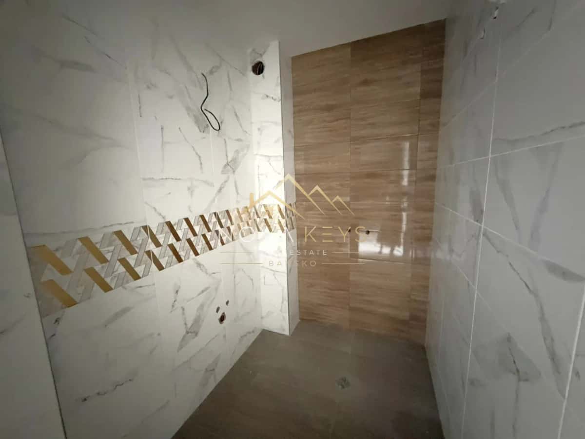 tiled shower room with wood-look wall panel, three-bedroom apartment for sale in the Bansko ski area.