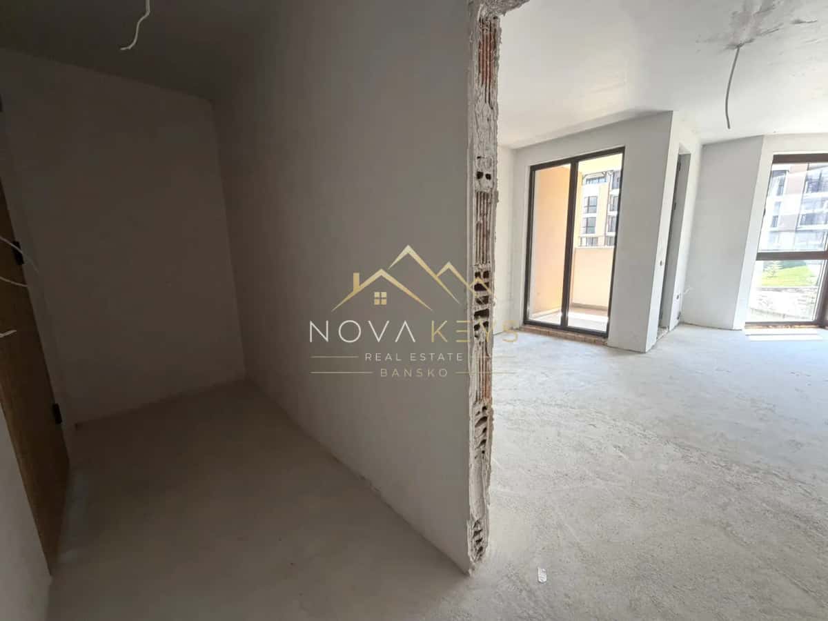 unfinished room with sliding glass doors, studio for sale in the Bansko ski area.