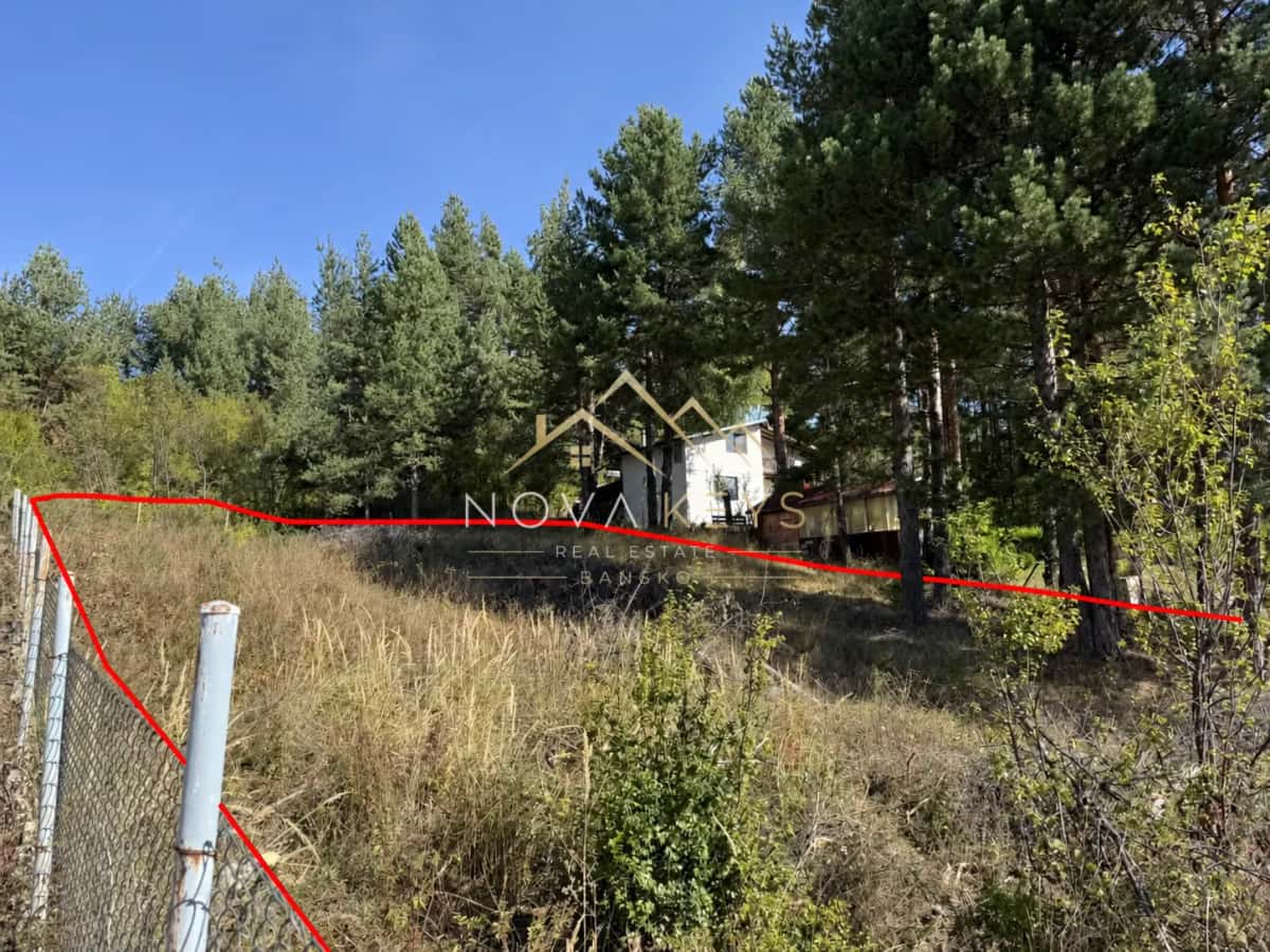 wooded hillside lot with fence and trees, plot for sale in Razlog.