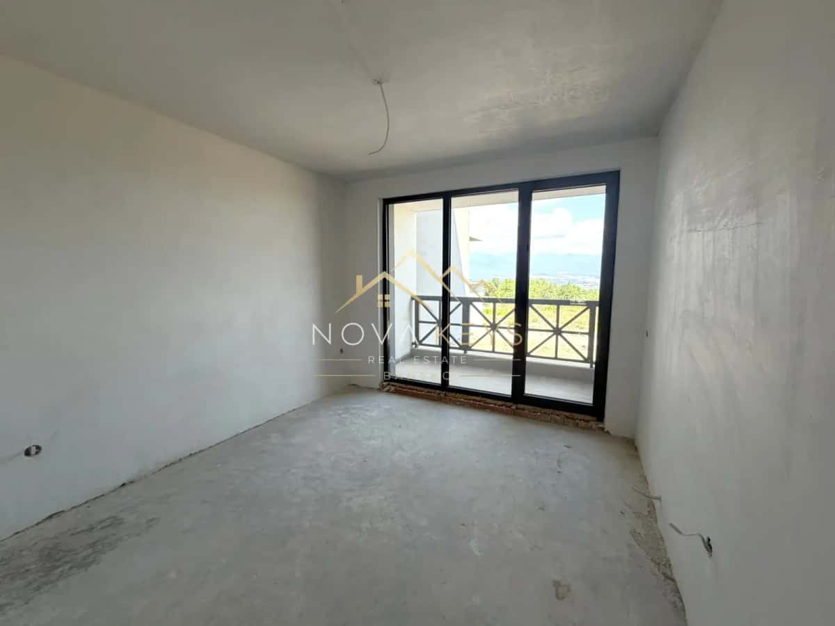 unfinished room with sliding glass door, three-bedroom apartment for sale in the Bansko ski area.