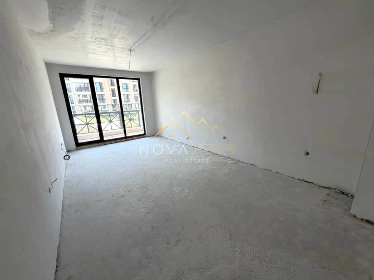 unfinished room with sliding glass doors, three-bedroom apartment for sale in the Bansko ski area.
