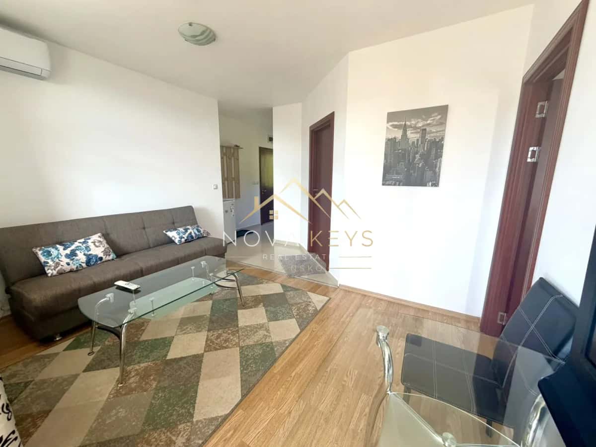 Living room with sofa and glass coffee table, two-bedroom apartment for sale in Razlog.