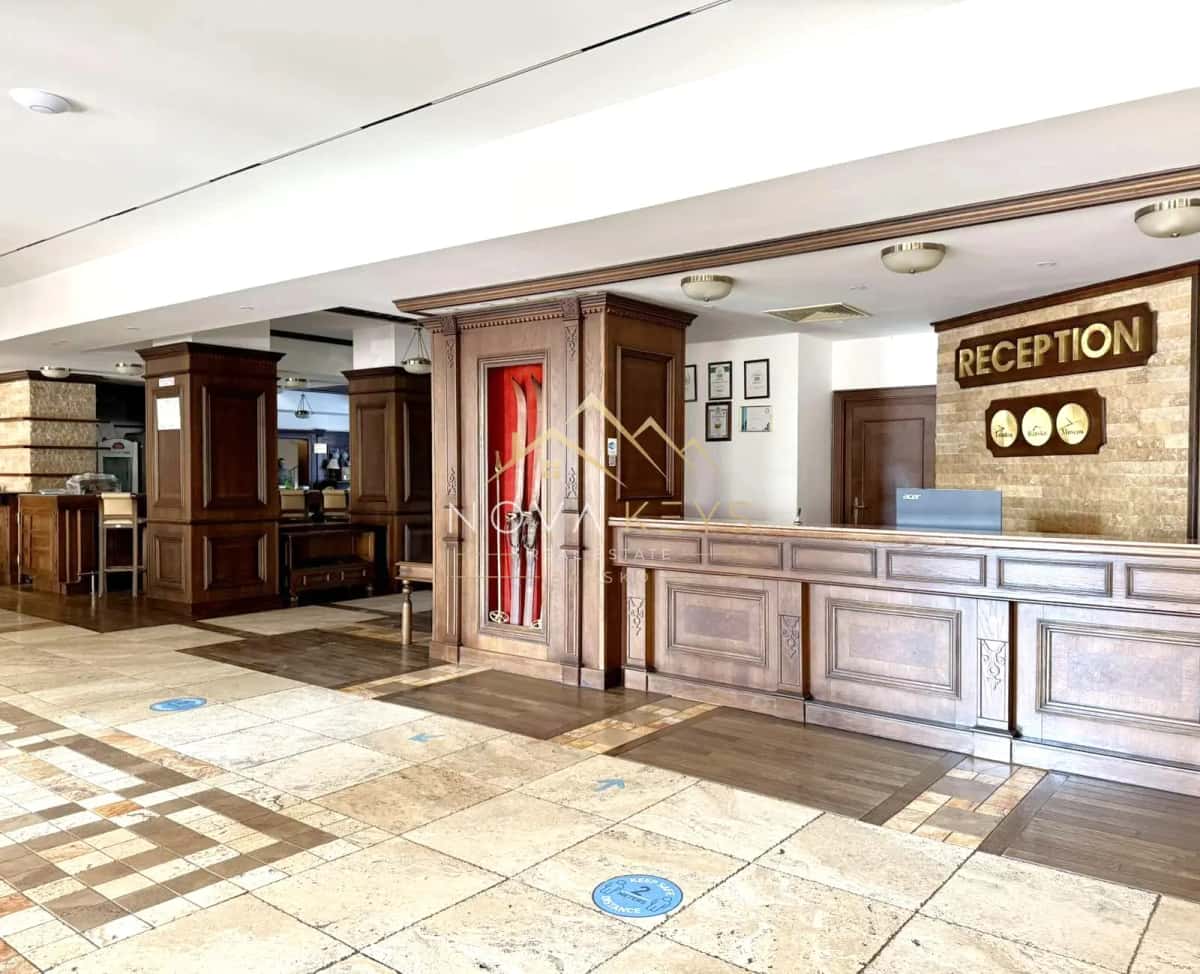Reception lobby with wooden desk, two-bedroom apartment for sale in the Bansko ski area.