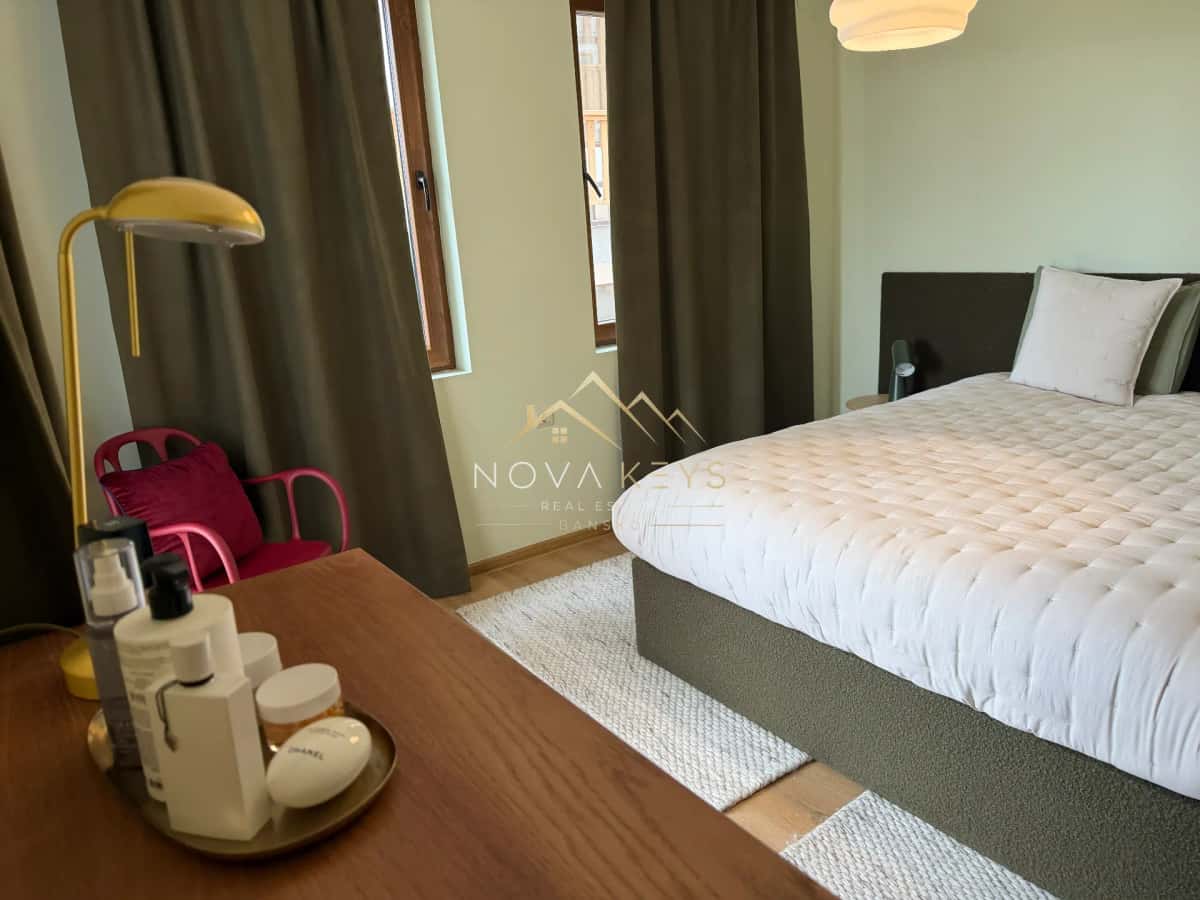 Bedroom with bed, desk, and accent chair, two-bedroom apartment for sale in Pirin Golf.