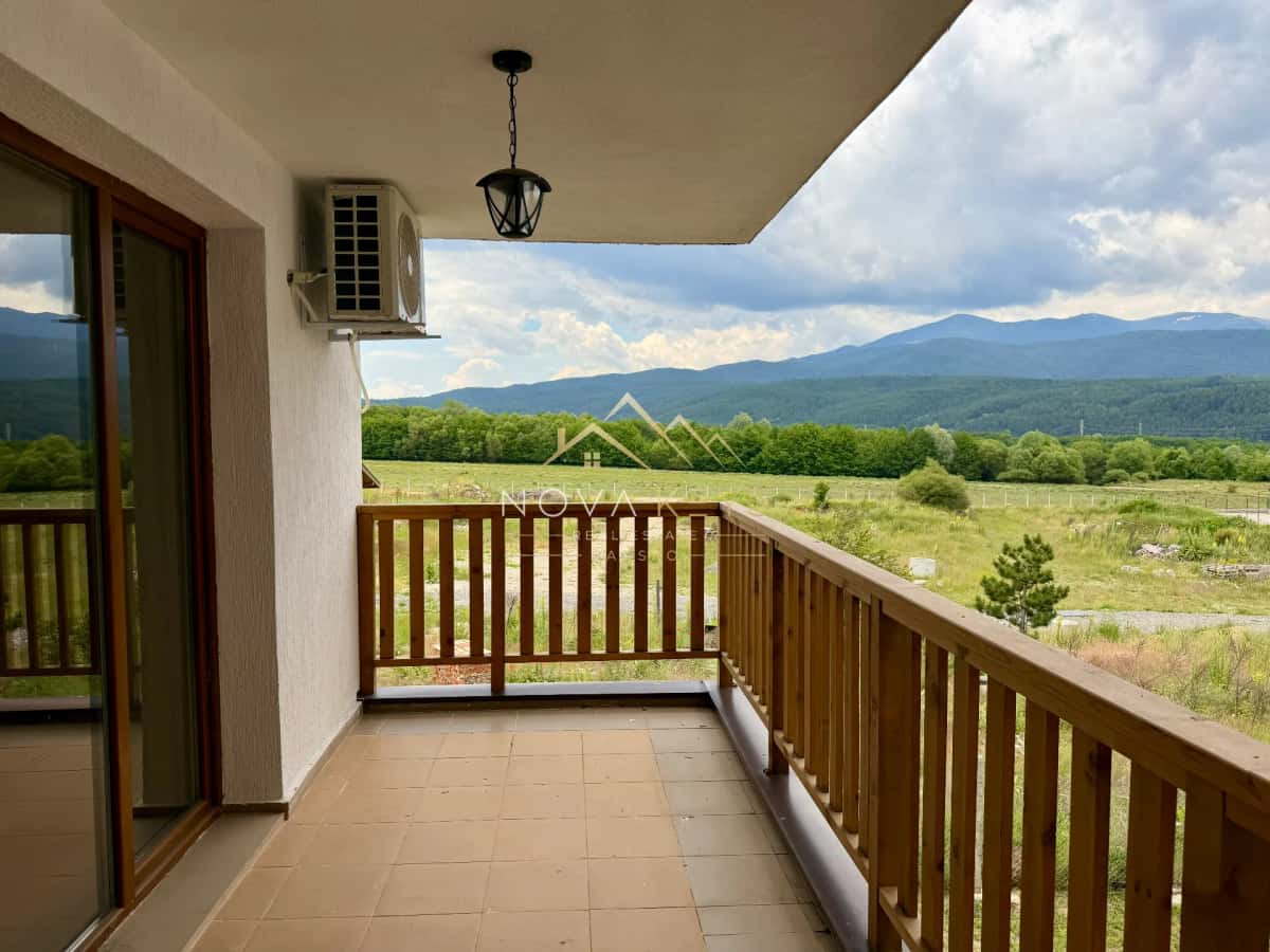 Covered balcony with wooden railing and mountain view, two-bedroom apartment for sale in Pirin Golf.