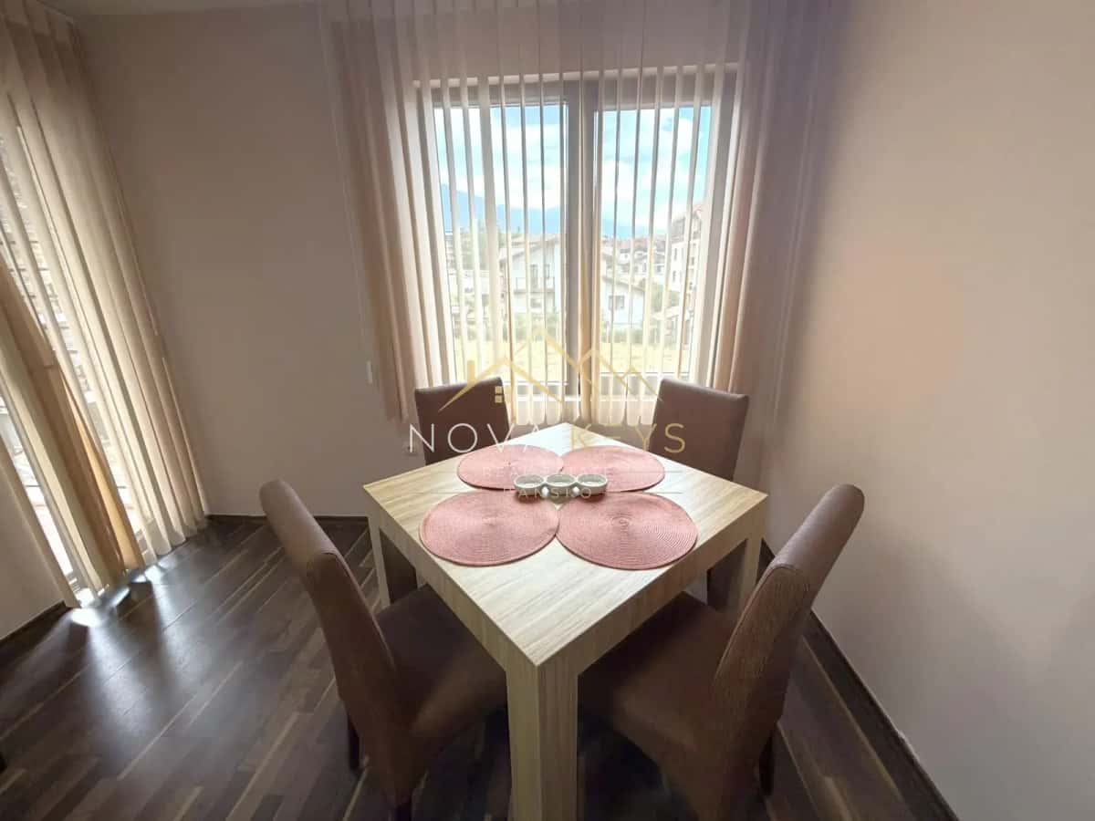 Dining nook with square table and four chairs, three-bedroom apartment for rent in the Bansko ski area.