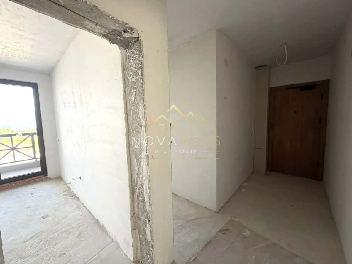 unfinished interior room with balcony door, three-bedroom apartment for sale in the Bansko ski area.