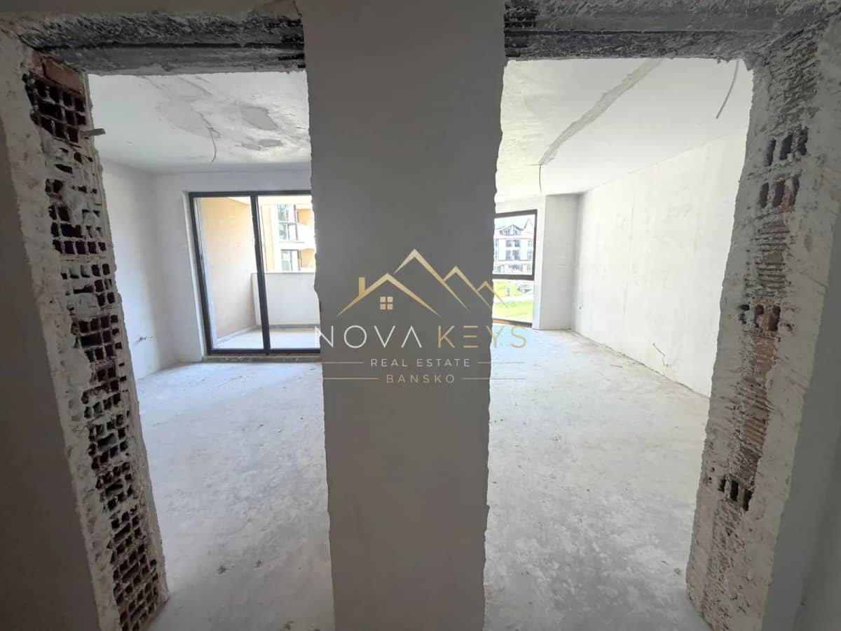 unfinished room with balcony doors and window, two-bedroom apartment for sale in the Bansko ski area.