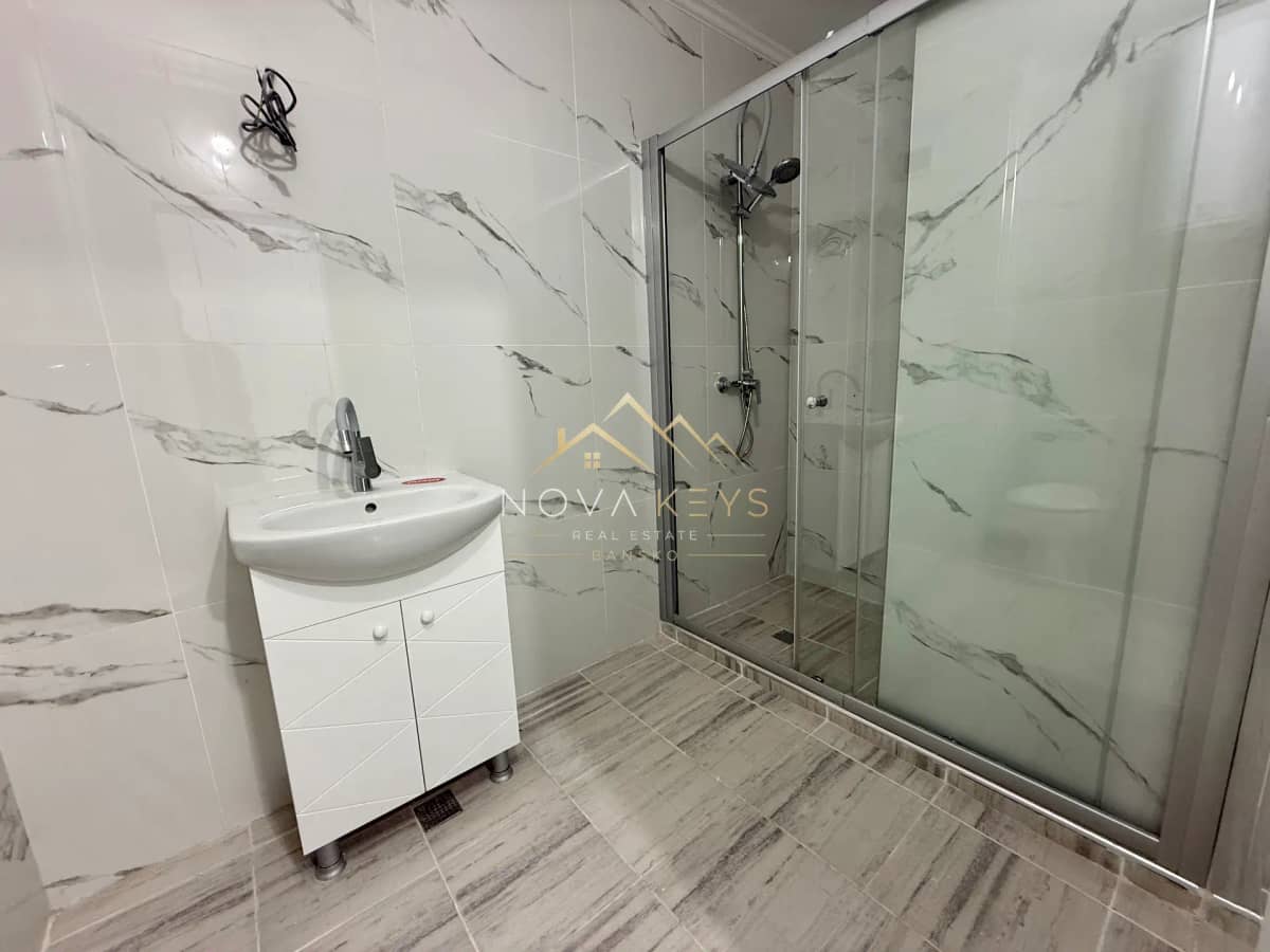 Bathroom with vanity and glass shower, two-bedroom apartment for sale in Bansko centre.