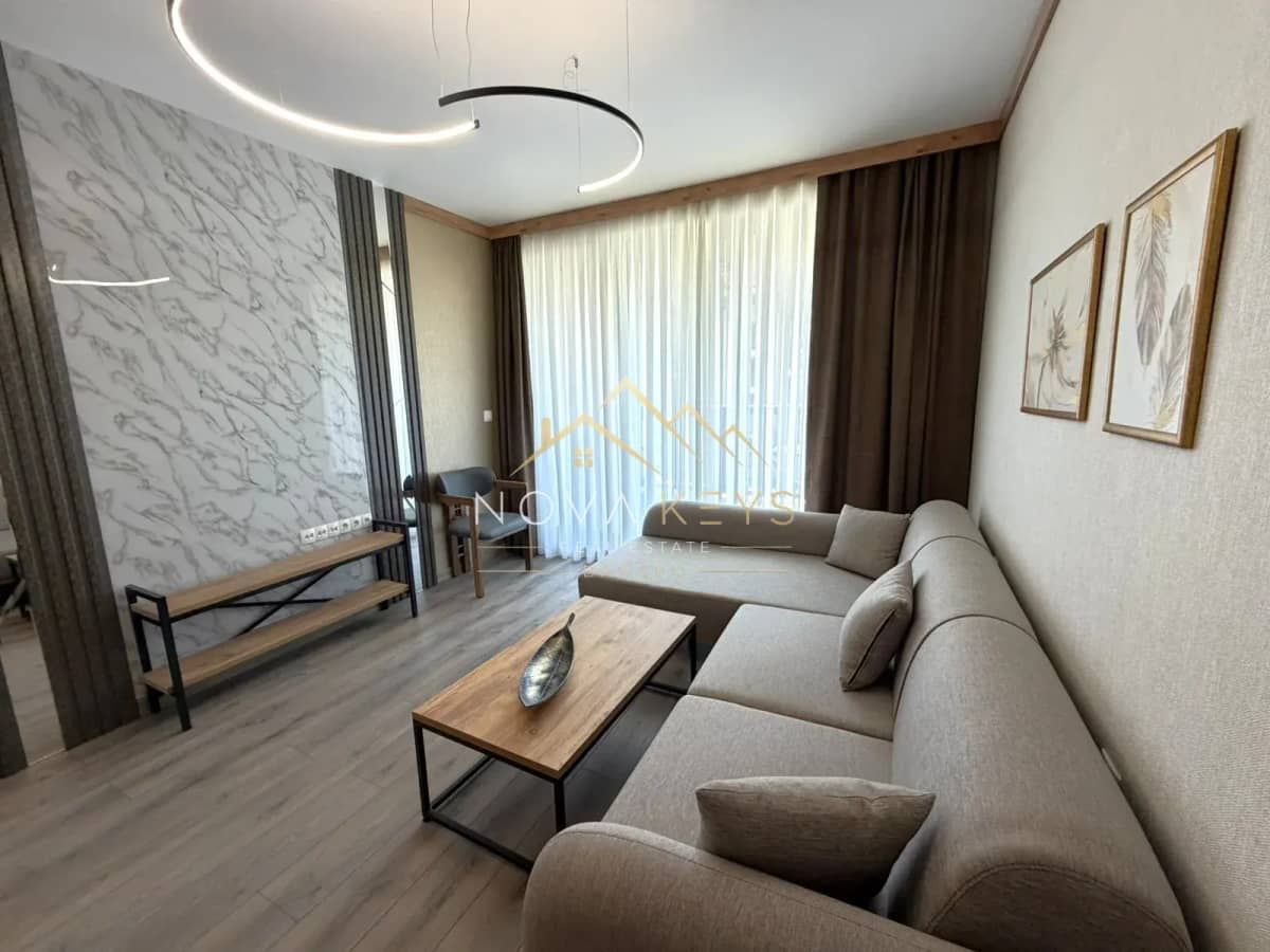 modern living room with sectional sofa and coffee table, three-bedroom apartment for sale in the Bansko ski area.