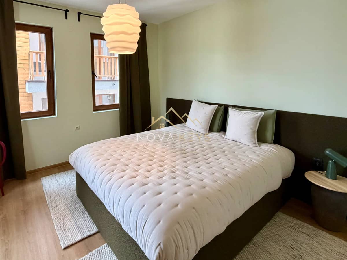 Bedroom with large bed and two windows, two-bedroom apartment for sale in Pirin Golf.