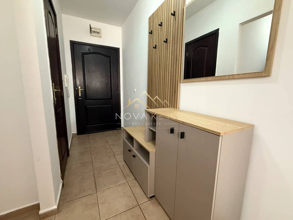 entry hallway with storage cabinet and mirror, three-bedroom apartment for rent in Bansko centre.