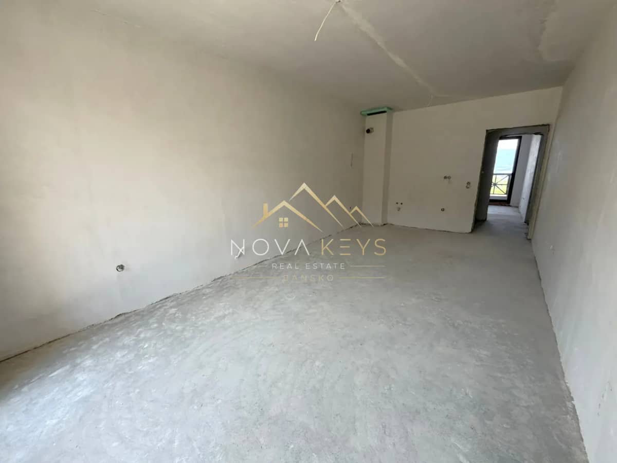unfinished room with concrete floor and doorway, three-bedroom apartment for sale in the Bansko ski area.