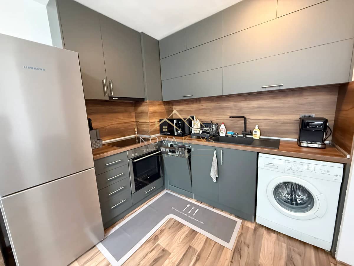 Modern kitchen with gray cabinets and appliances, three-bedroom apartment for rent in Bansko centre.
