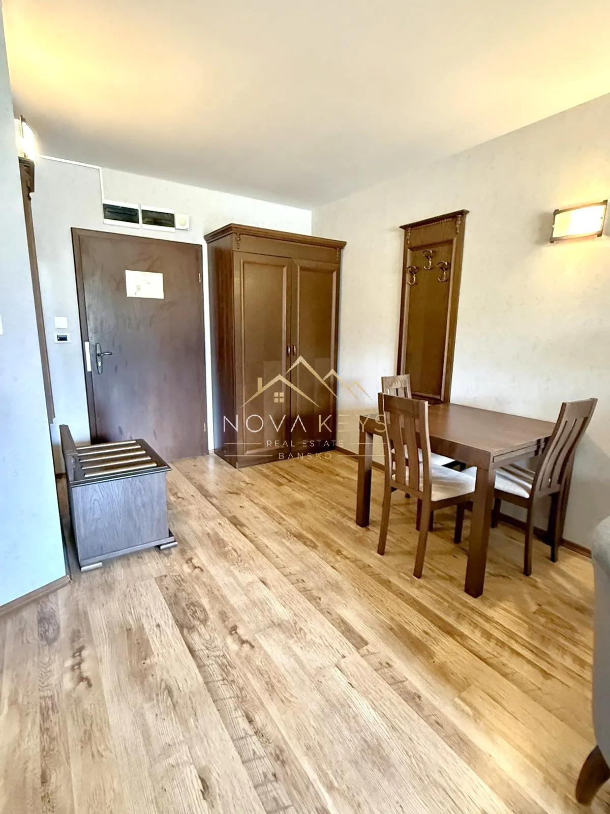 furnished room with dining table and wardrobe, two-bedroom apartment for sale in the Bansko ski area.