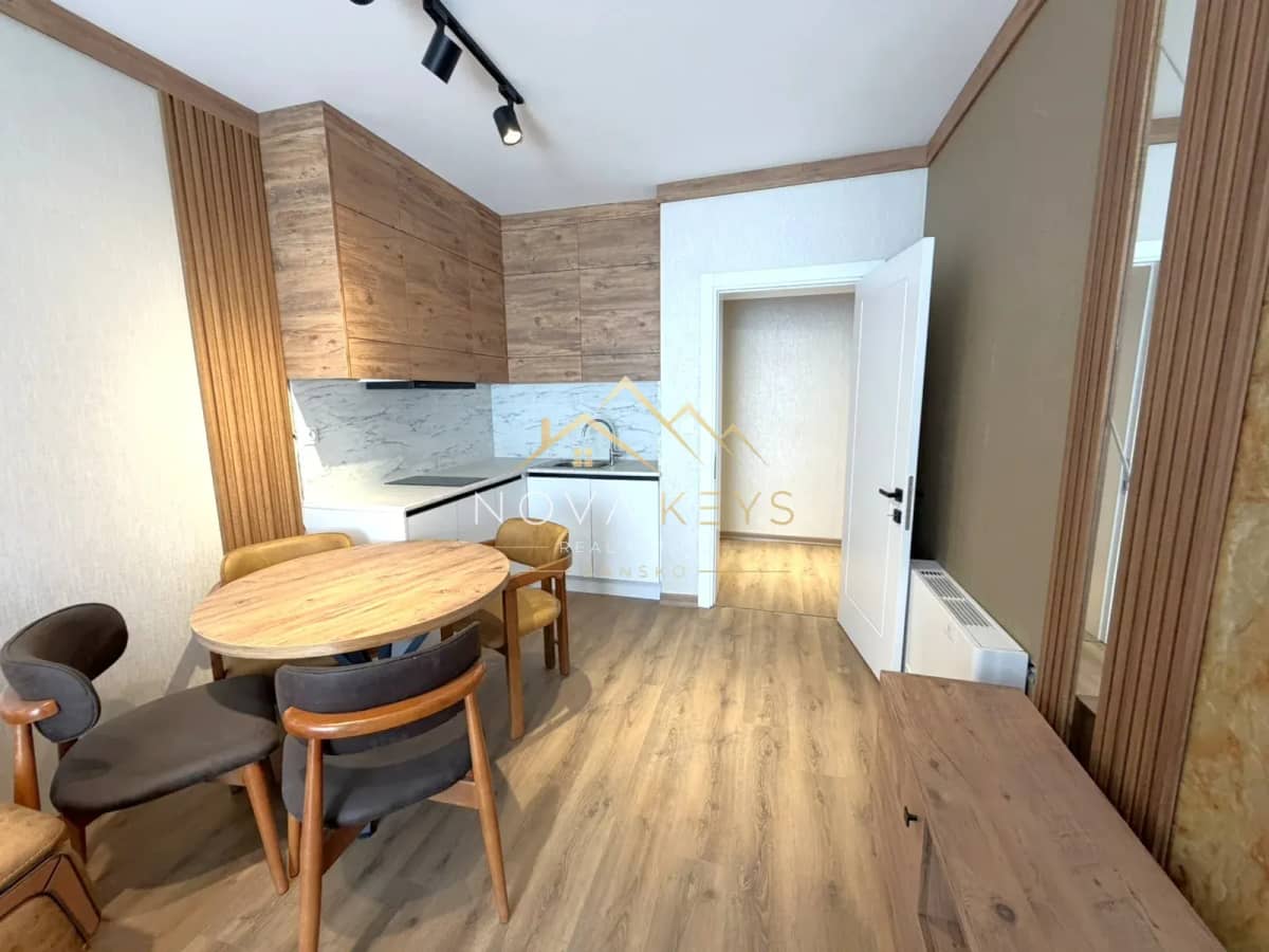 modern kitchen dining area with wooden table and chairs, two-bedroom apartment for sale in the Bansko ski area.