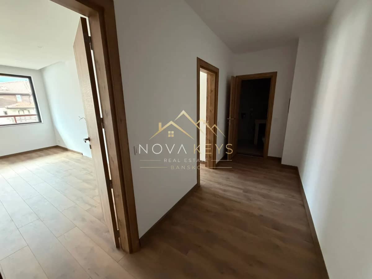 empty hallway with wooden doors, three-bedroom apartment for sale in the Bansko ski area.