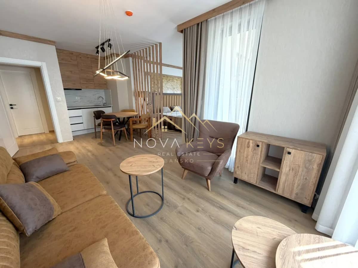 Open-plan living room with sofa and kitchen, studio for sale in the Bansko ski area.