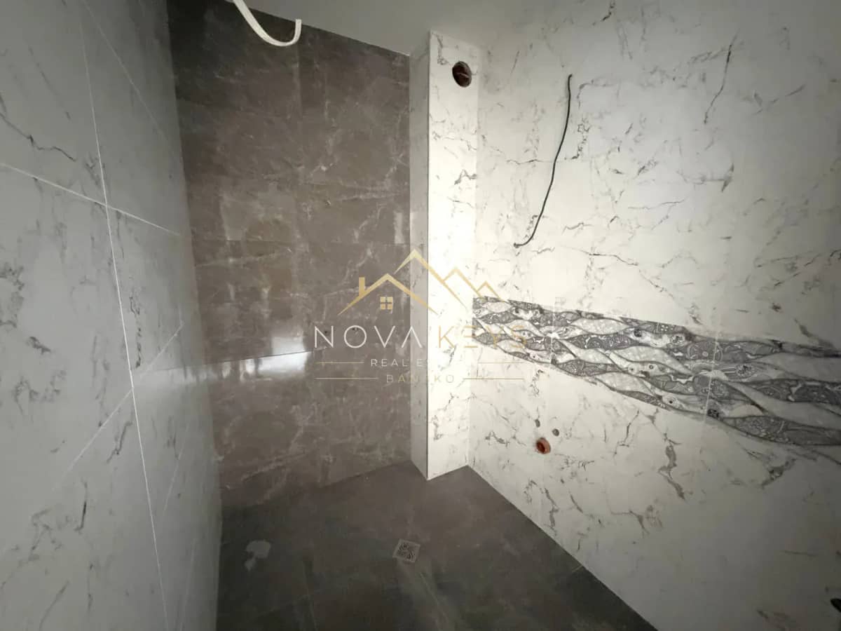 unfinished tiled shower area, two-bedroom apartment for sale in the Bansko ski area.