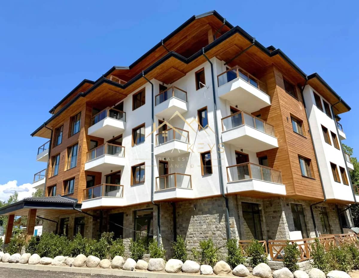 Modern apartment building exterior with balconies, two-bedroom apartment for sale in the Bansko ski area.