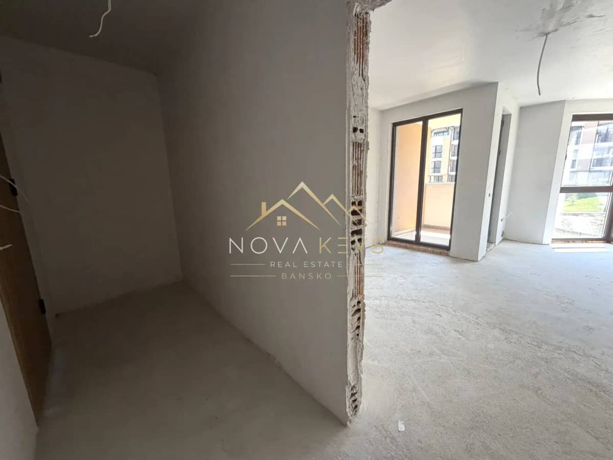 unfinished room with sliding glass doors, studio for sale in the Bansko ski area.