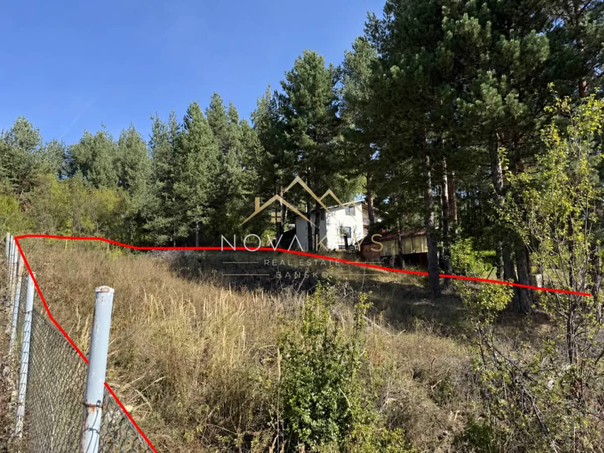 wooded hillside lot with fence and trees, plot for sale in Razlog.