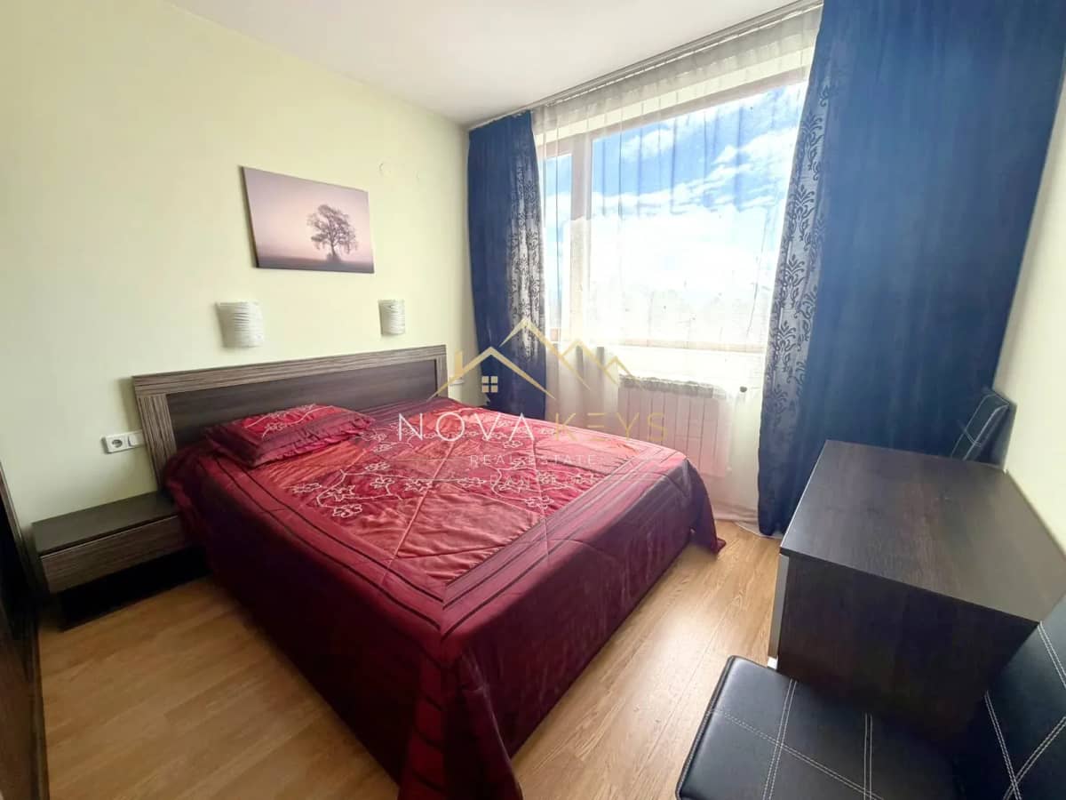 Bedroom with double bed and blue curtains, two-bedroom apartment for sale in Razlog.