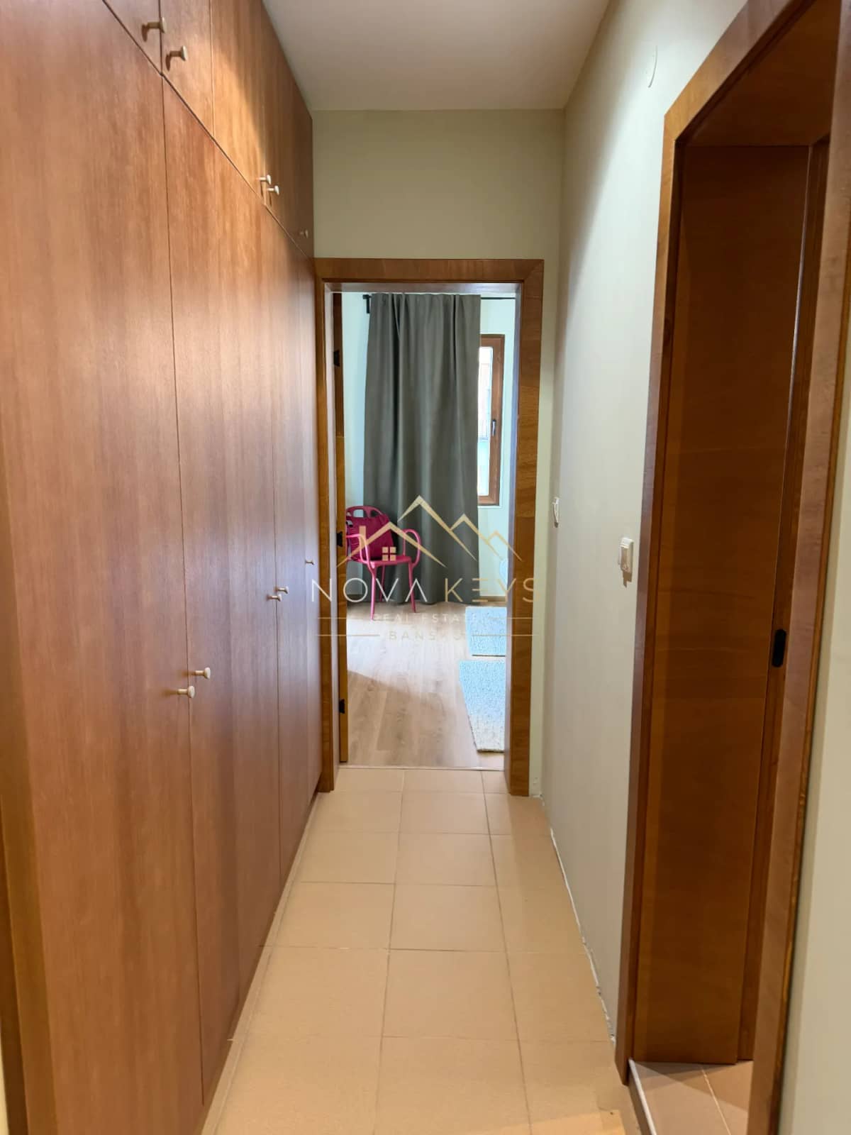 Narrow hallway with built-in wooden wardrobes, two-bedroom apartment for sale in Pirin Golf.