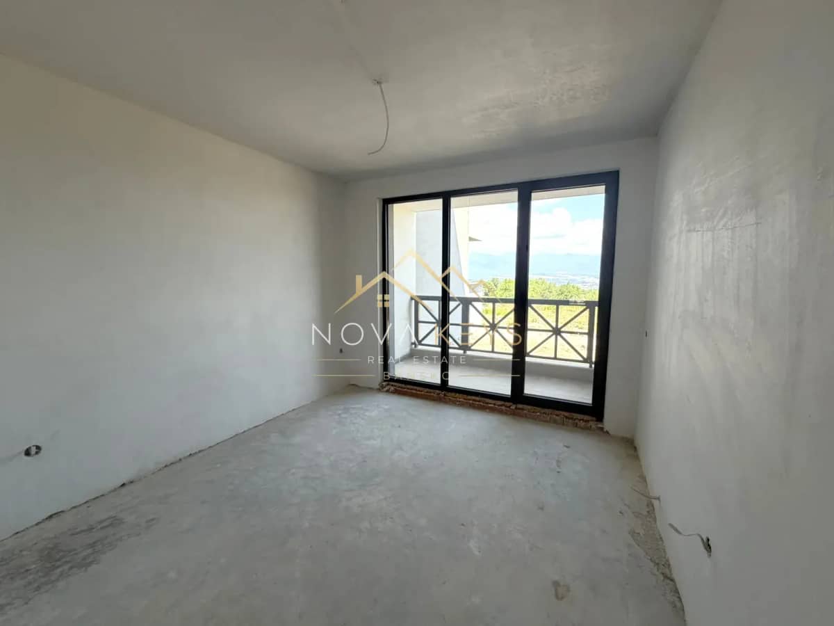 unfinished room with sliding glass door, three-bedroom apartment for sale in the Bansko ski area.