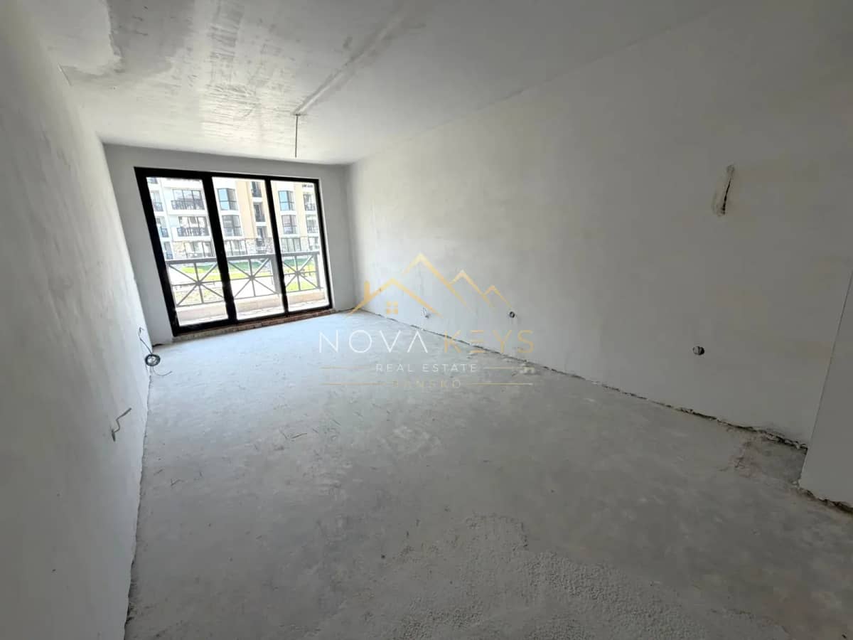unfinished room with sliding glass doors, three-bedroom apartment for sale in the Bansko ski area.