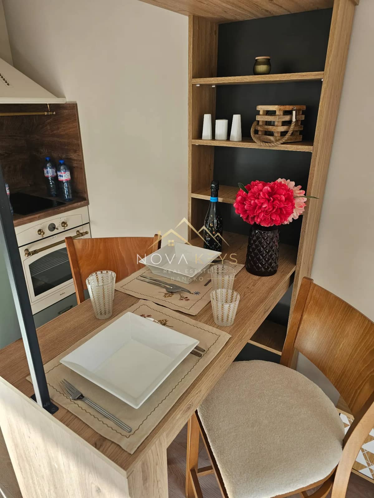 Dining nook with wooden table and chairs, studio for sale in the Bansko ski area.