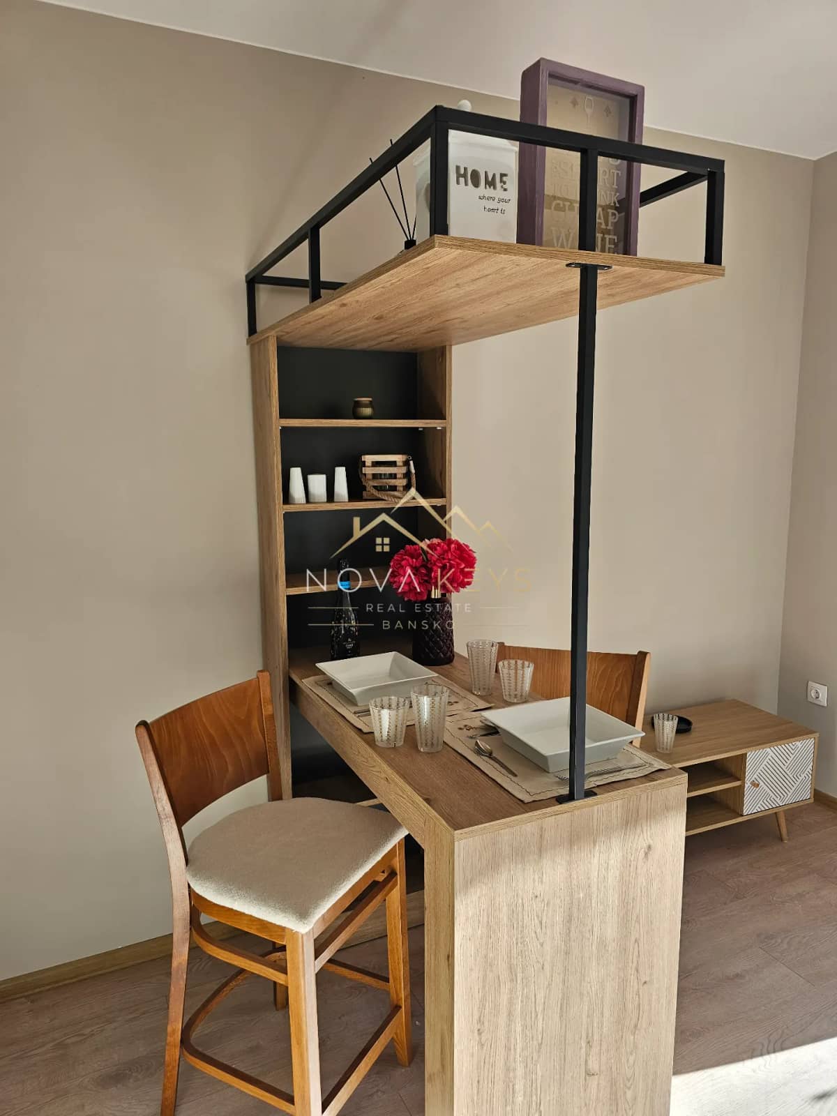 Dining nook with wooden table and shelving, studio for sale in the Bansko ski area.