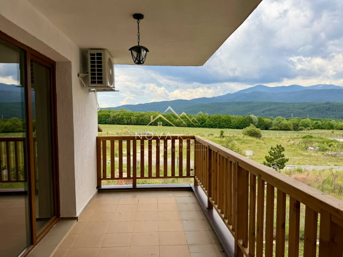 Covered balcony with wooden railing and mountain view, two-bedroom apartment for sale in Pirin Golf.