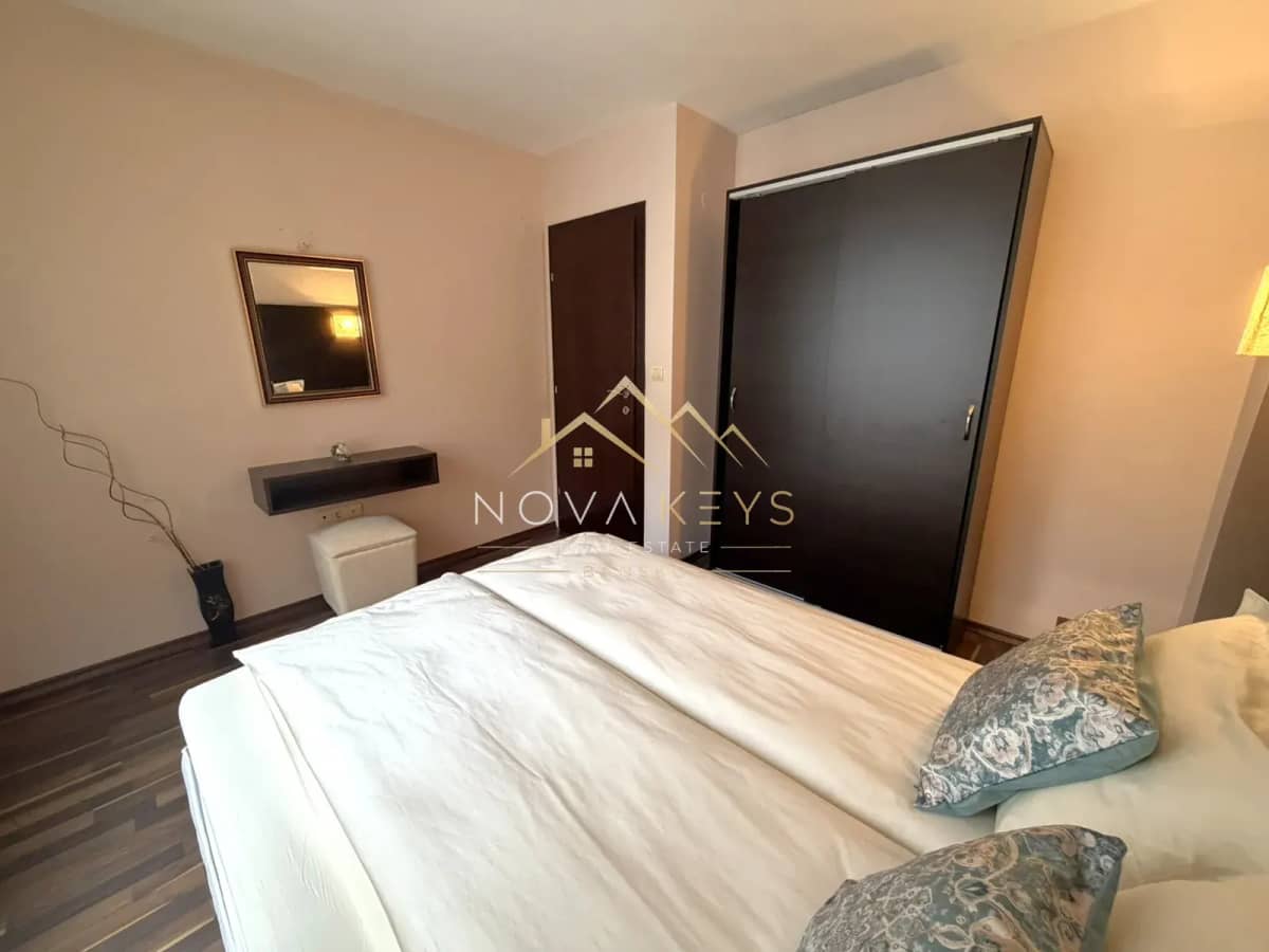 Bedroom with double bed and dark wardrobes, three-bedroom apartment for rent in the Bansko ski area.