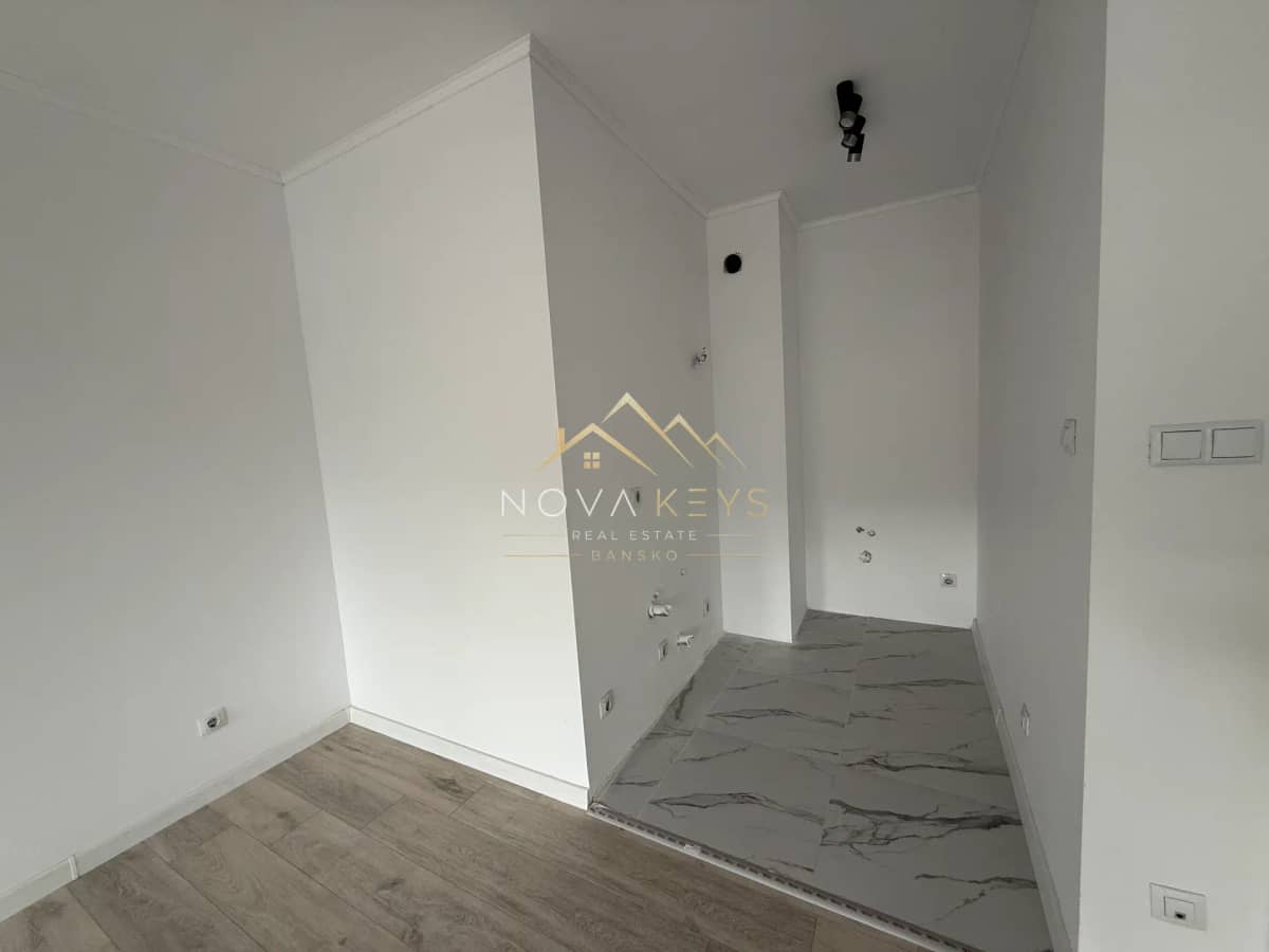 Empty room with tiled utility nook, two-bedroom apartment for sale in Bansko.