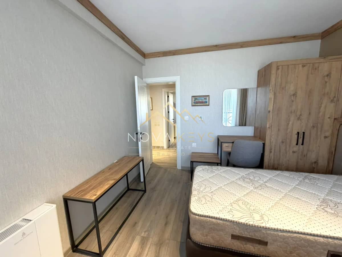 furnished bedroom with bed, wardrobe, and desk, three-bedroom apartment for sale in the Bansko ski area.