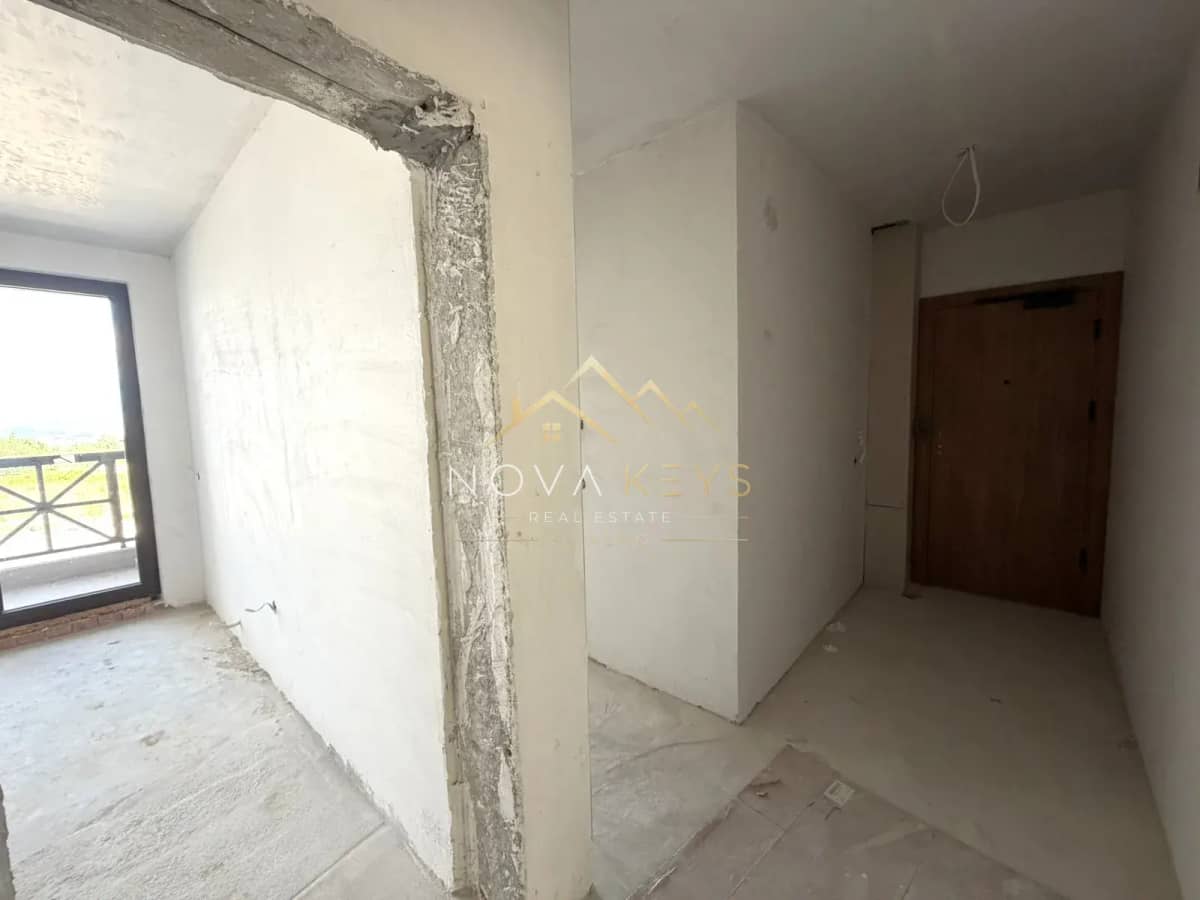 unfinished interior room with balcony door, three-bedroom apartment for sale in the Bansko ski area.