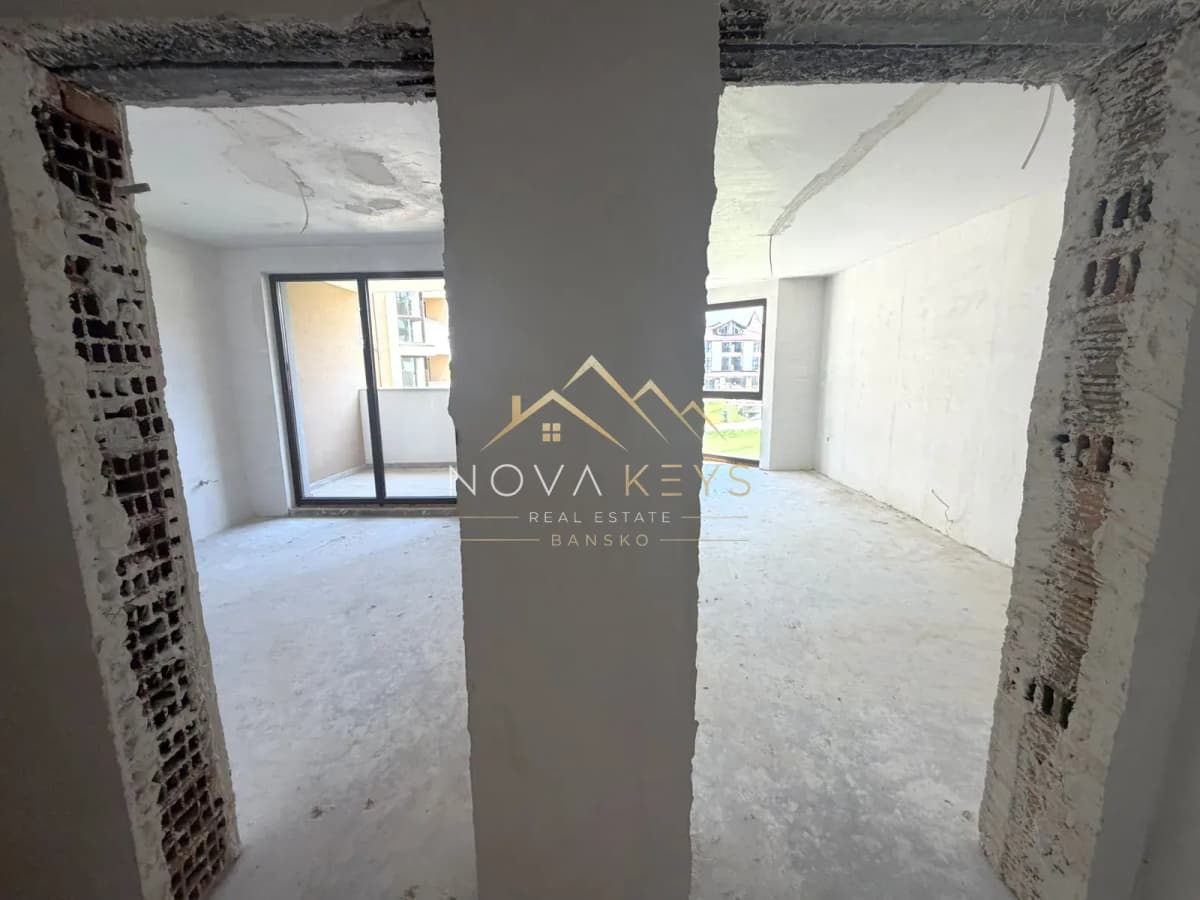 unfinished room with balcony doors and window, two-bedroom apartment for sale in the Bansko ski area.